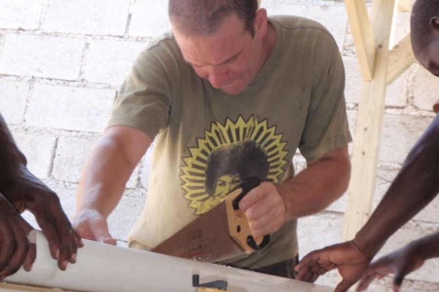 Builder measuring and marking a length of timber