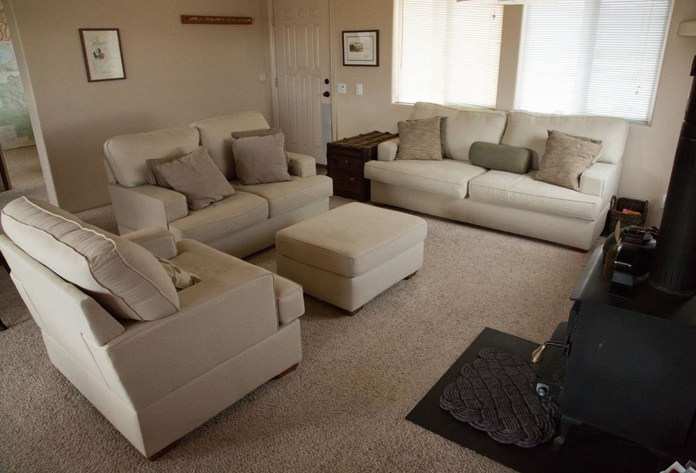 Calm living room with cream sofas and soft light