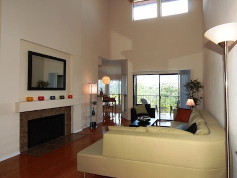 Bright living room with cream sofas and a fireplace