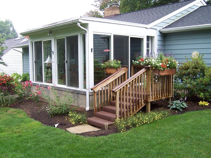 Sunroom addition with new timber steps and fresh garden beds