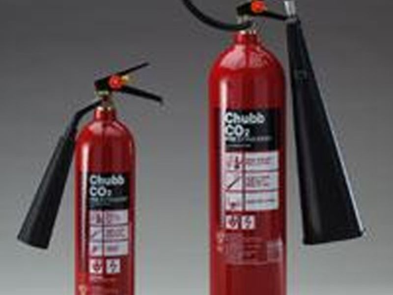 Two red fire extinguishers ready for use